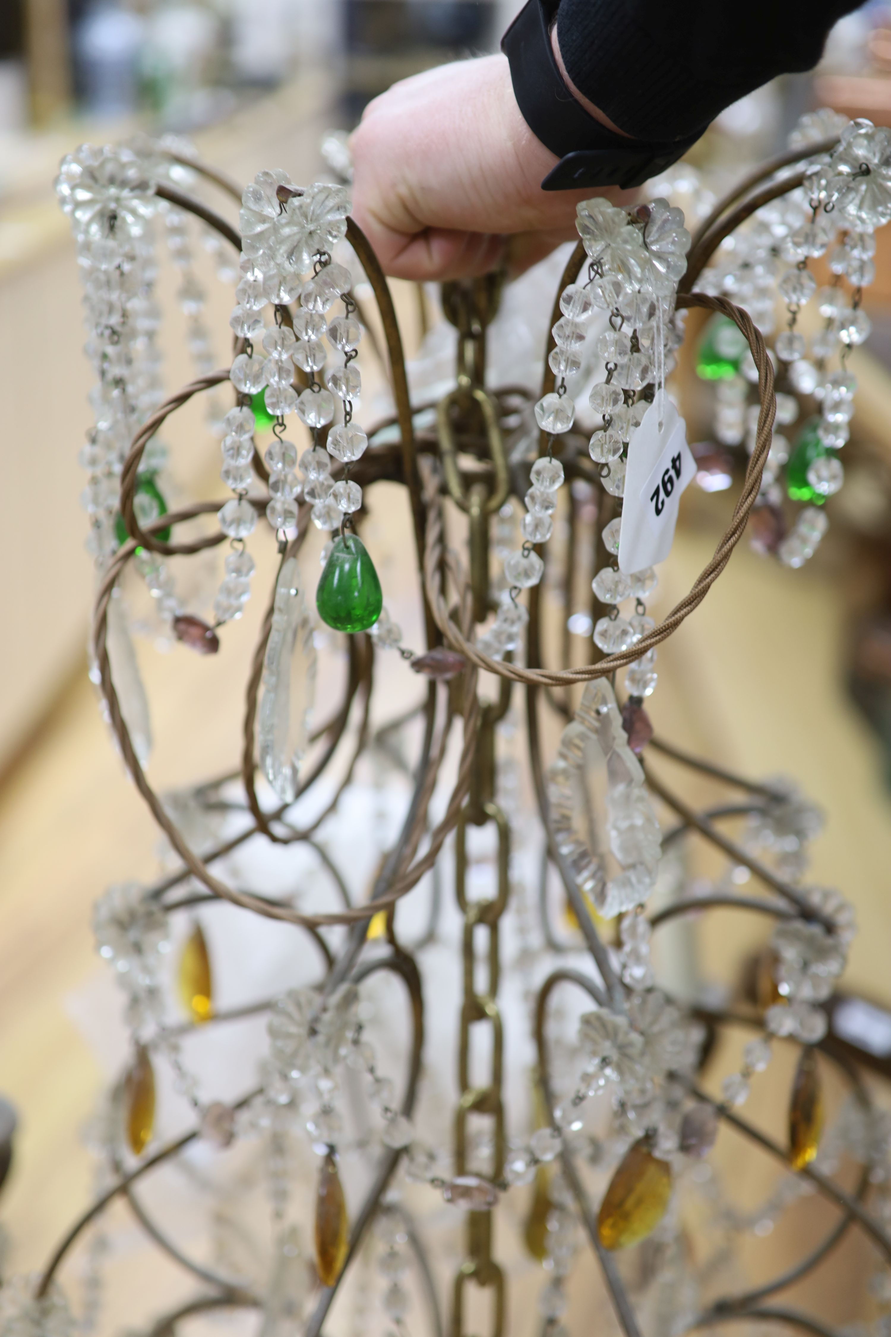 An eight branch glass drop chandelier